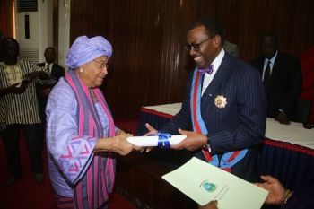  President Sirleaf presents certificate of honor to Dr. Adesina at the Investiture ceremony.